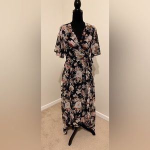 Long dress. Long on the back/shorter on the front. Flower detail.